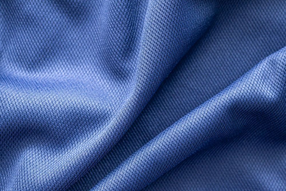 Close-up of textured blue fabric with soft folds and ripples