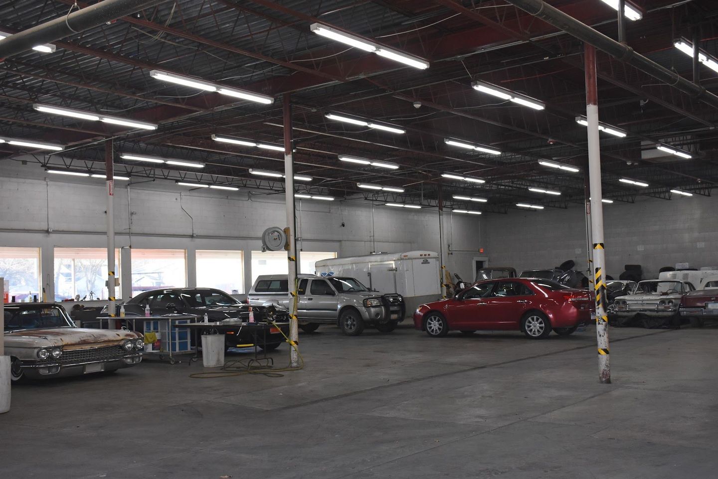Auto Repair Shop Interior With Multiple Vehicles Under Service | MCCJ Auto Group