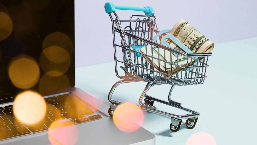 a shopping cart with a roll of twenty dollar bills in it