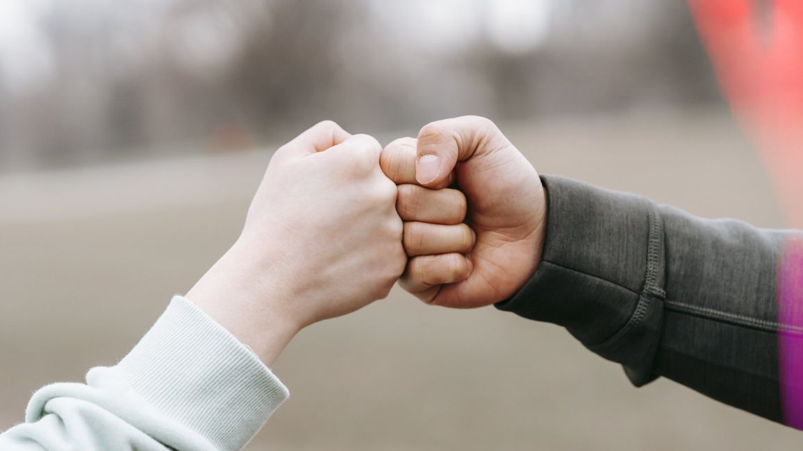 trusting fist bump man and women