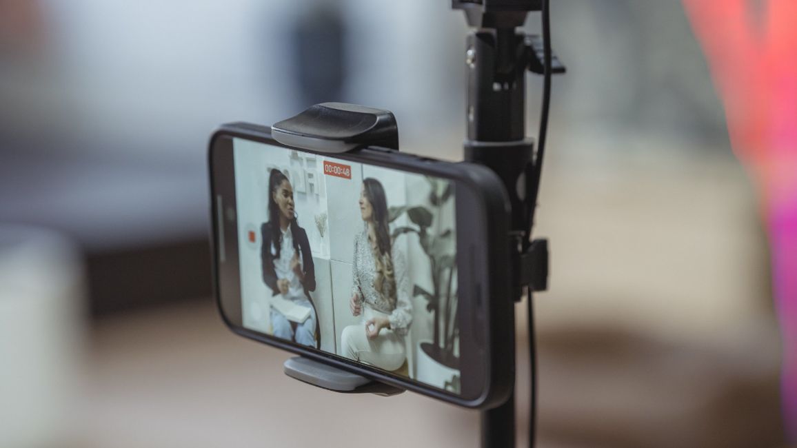 a cell phone is being recorded on a tripod .