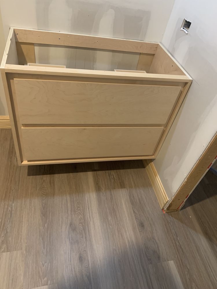 Wooden changing table or cabinet against a wall on a wood floor in a room corner