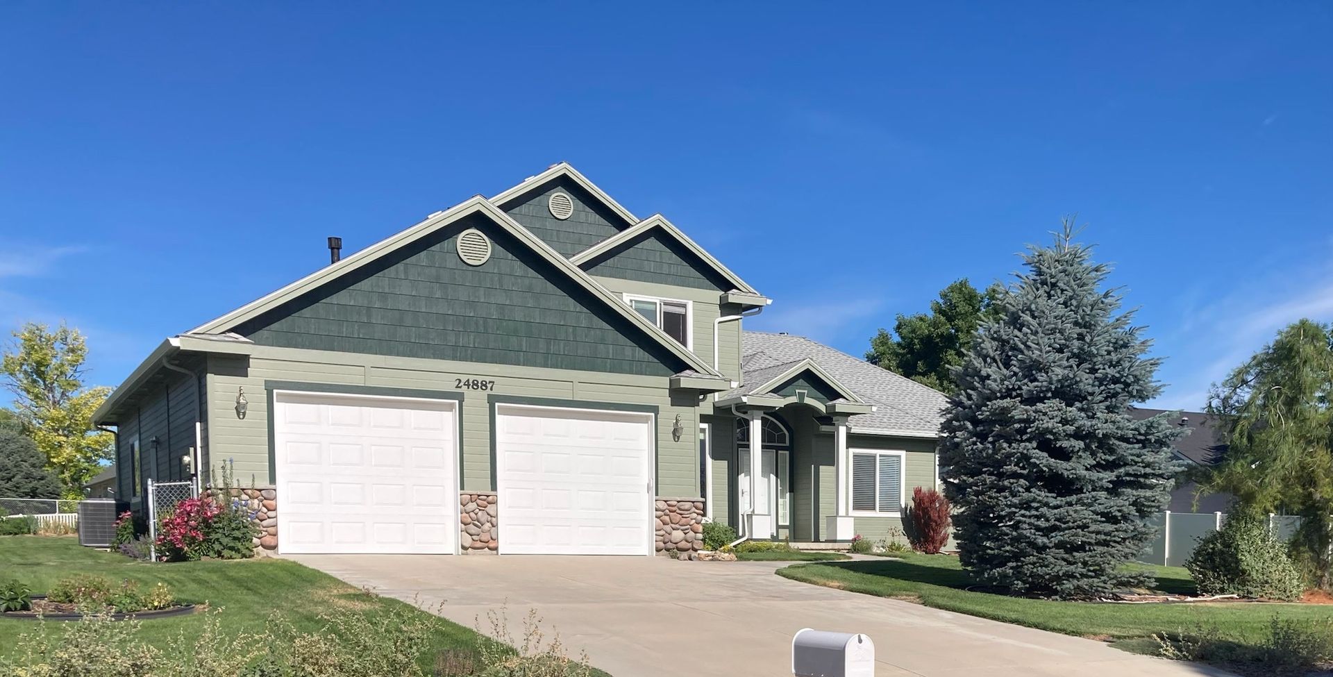 Big Blue House with garage doors — Caldwell, ID — Busy Bee Painting