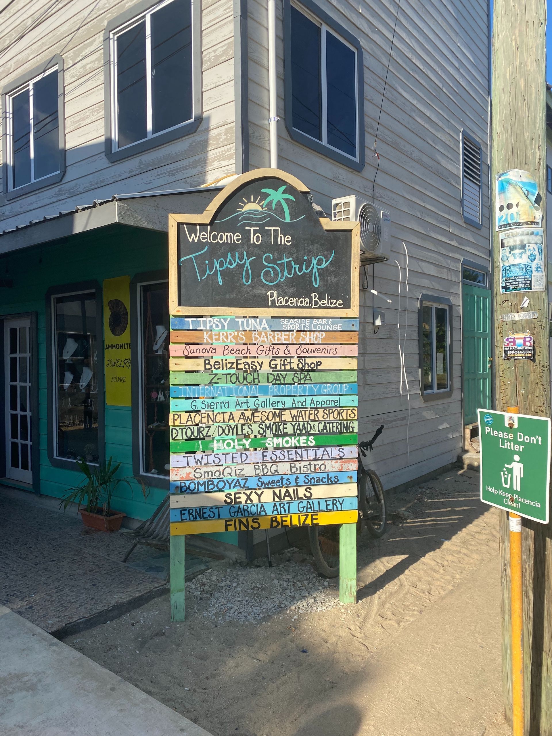 Colorful chalkboard sign outside a storefront listing menu items and hours