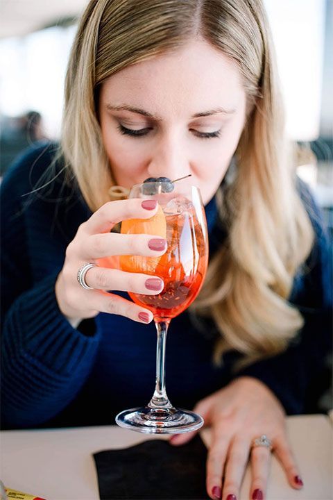 woman is drinking a cocktail