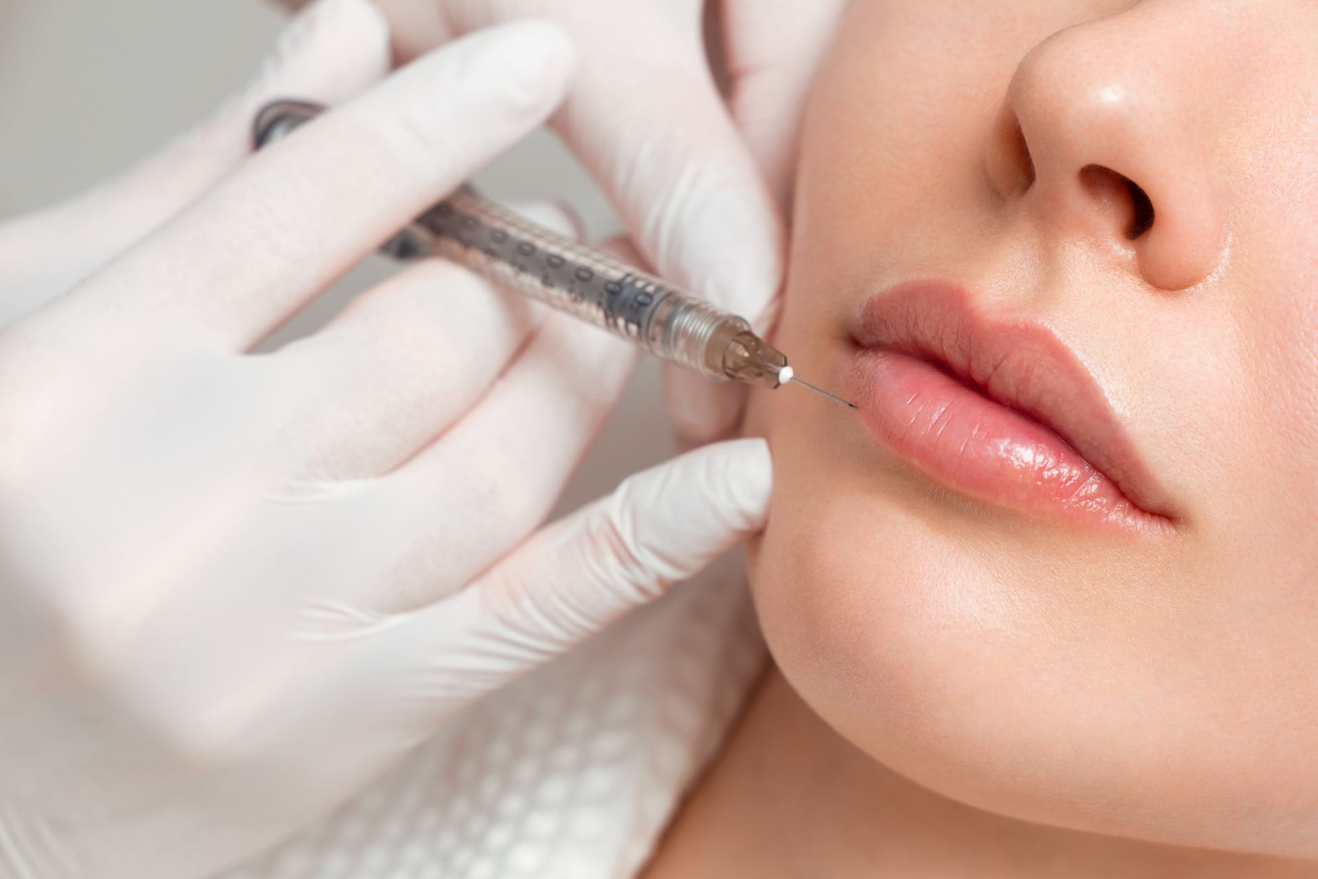 Young woman receiving a botox injection.