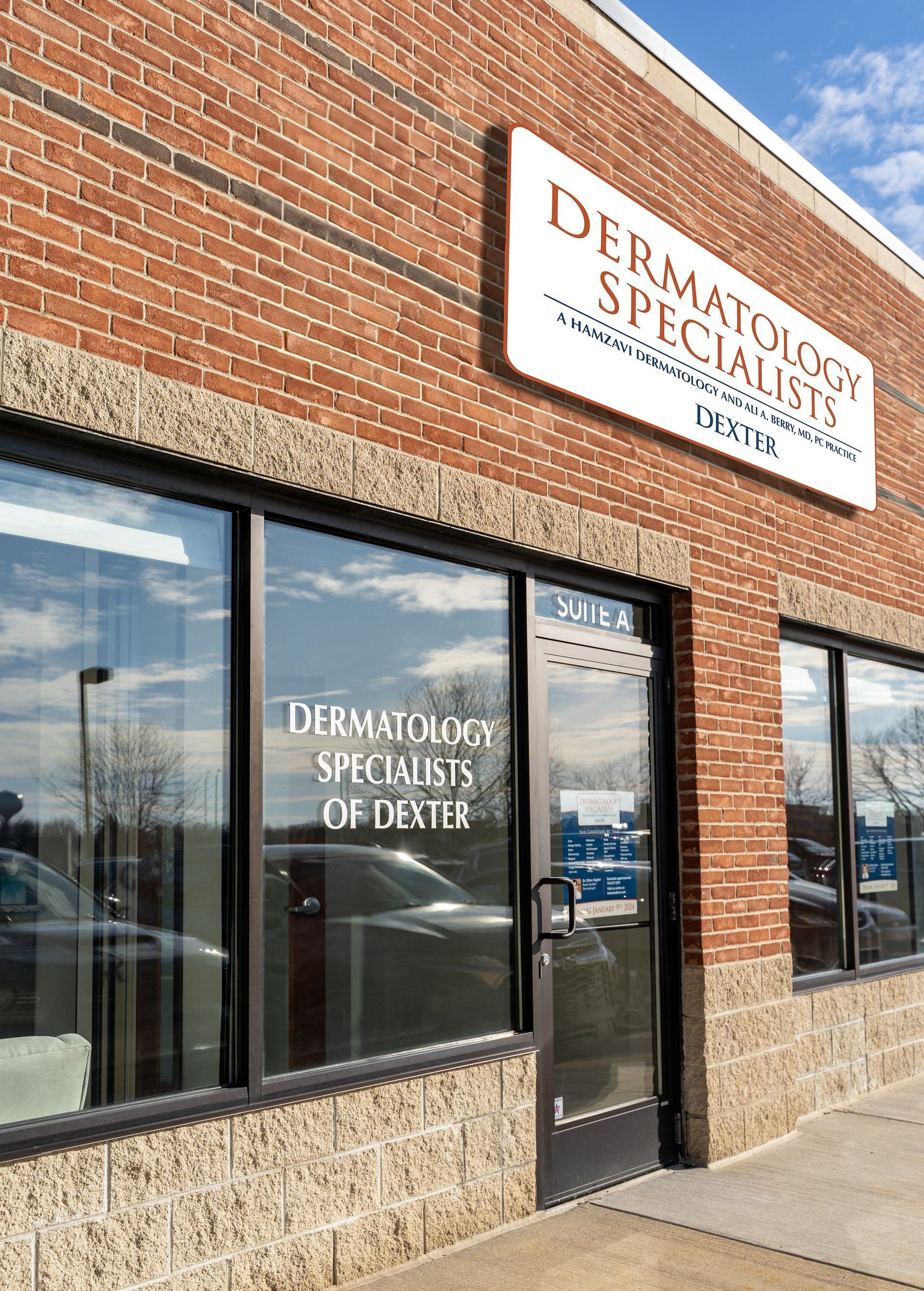Dermatology Specialists of Dexter office exterior with brick facade and large windows.