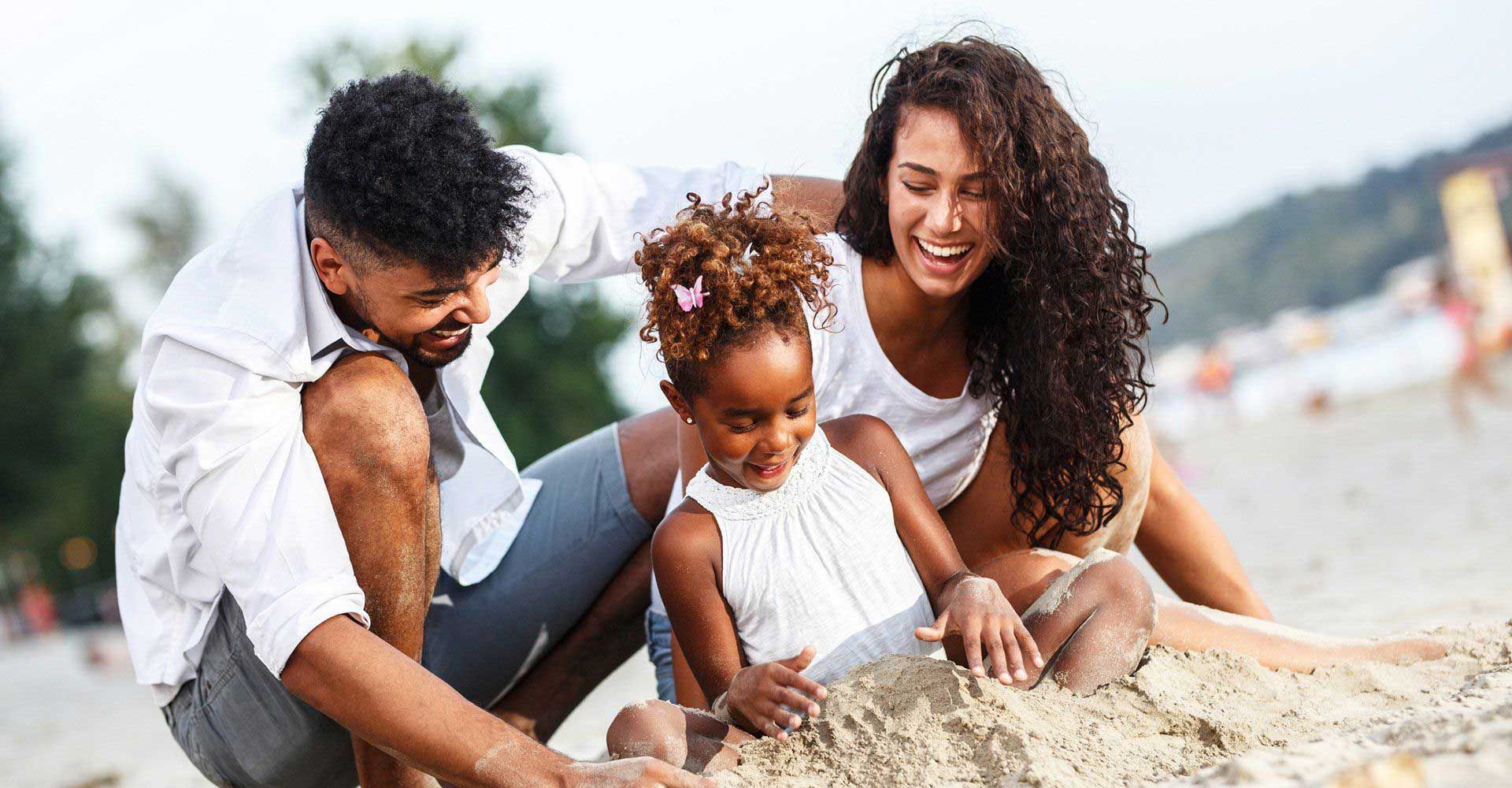 Family Relaxing at the Beach — Fort Gratiot, MI — Hamzavi Dermatology & Dermatology Specialists A family enjoying the beach after having skin cancer screening in Brighton, MI