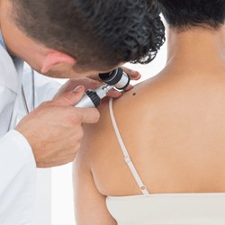 Male Doctor Examining the Patient's Shoulder — Fort Gratiot, MI — Hamzavi Dermatology & Dermatology Specialists Male Doctor Examining the Patient's Shoulder — Fort Gratiot, MI — Hamzavi Dermatology & Dermatology Specialists
