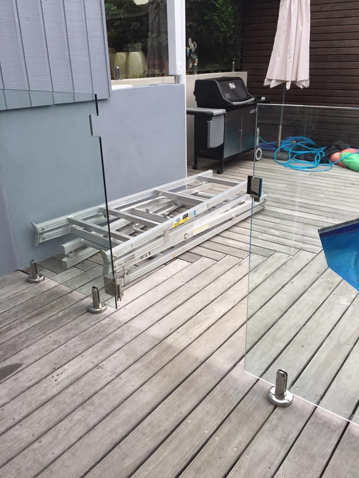 A Ladder Is Sitting On A Wooden Deck Next To A Pool — Avoca Beach Glass In West Gosford, NSW