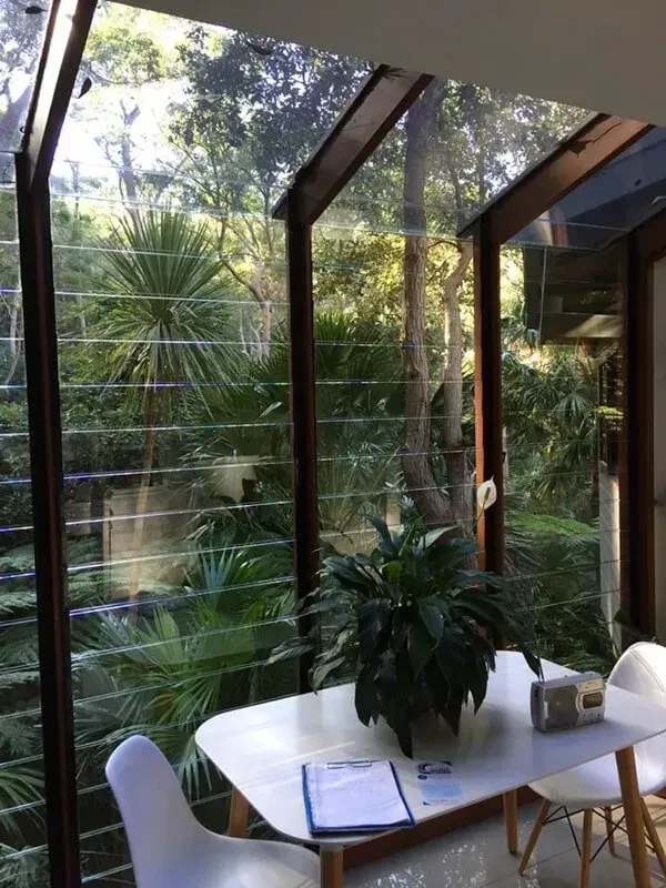 A Table And Chairs In A Room With A Plant On It — Avoca Beach Glass In West Gosford, NSW
