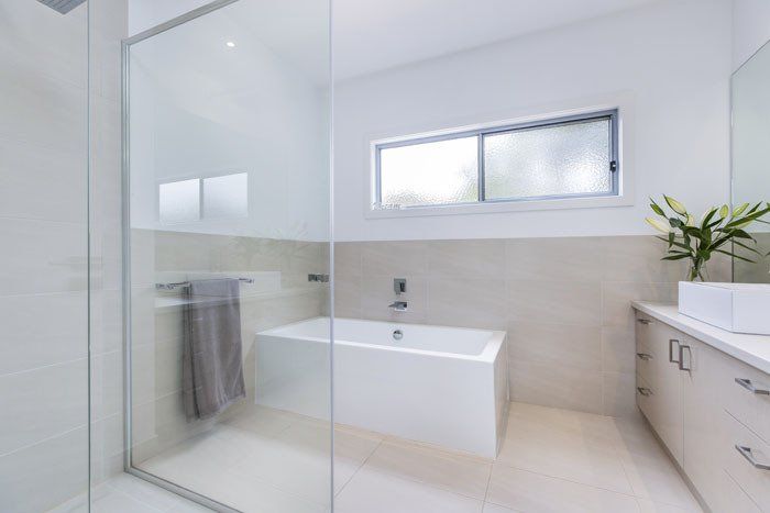 Clean Bathroom With Glass Divider — Rye, VIC — Quin Wyatt Building Designers