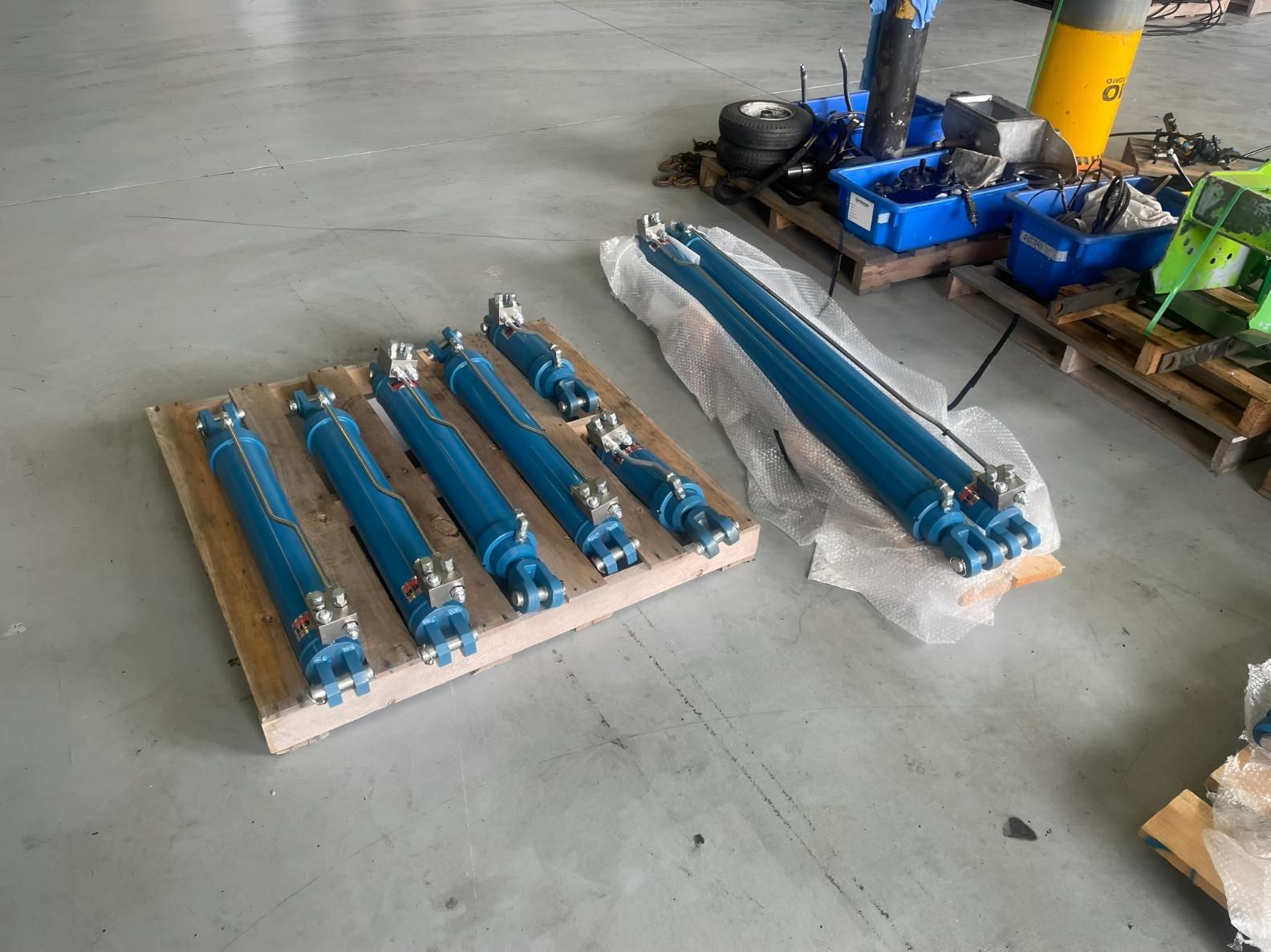 A Bunch Of Blue Cylinders Are Sitting On A Wooden Pallet — Mackay Hose Fitting Services In West Mackay, QLD