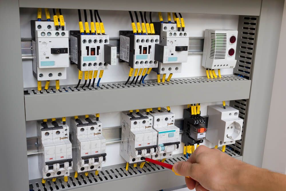Technician Working at Electrical Cabinet — Electrical Services in Uralla, NSW