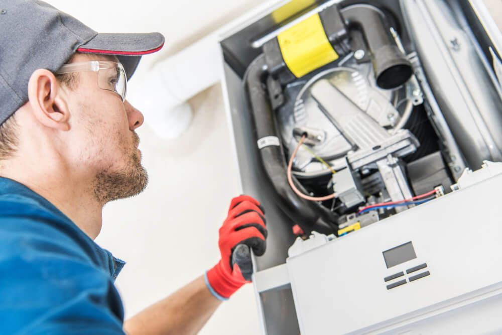 Electrician Checking Hot Water System — Electrical Services in Walcha, NSW