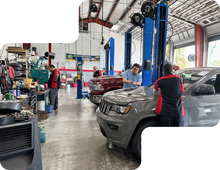 Mechanics working on a car in a garage.  | Premier Auto Service Center