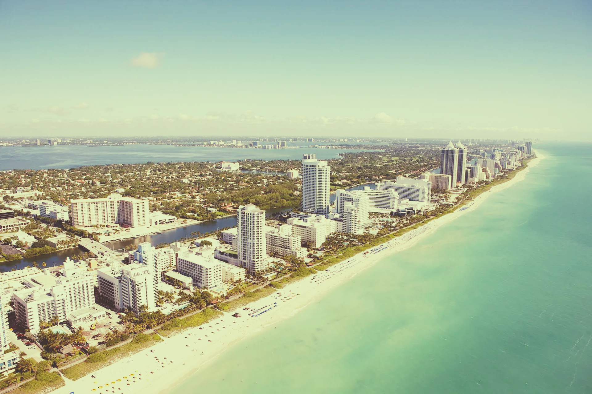 An aerial view of a city along the coast of florida.