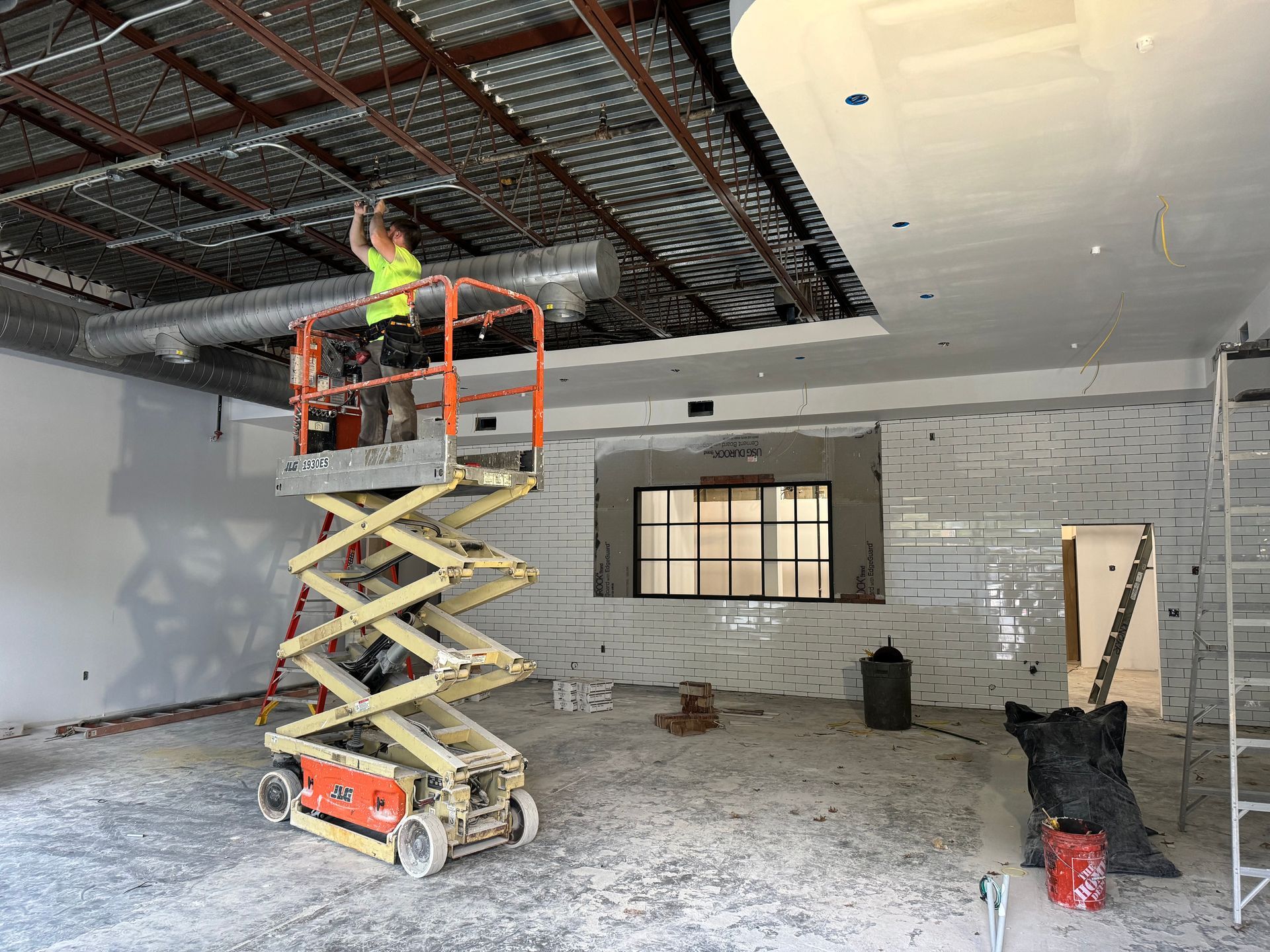 Commercial restaurant interior with recessed ceiling lights and illuminated service counter