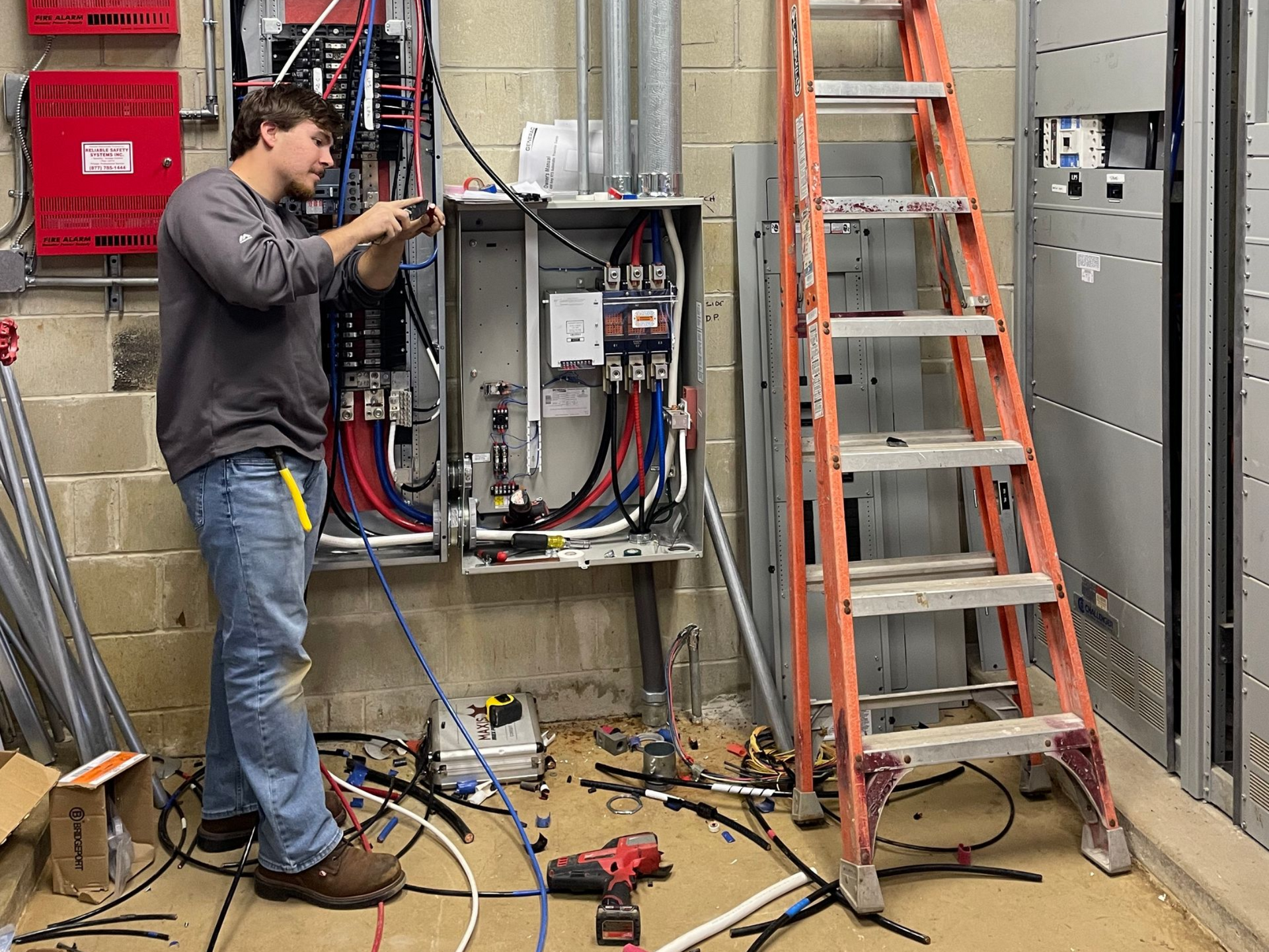 Commercial electrician working on electrical wiring and distribution equipment