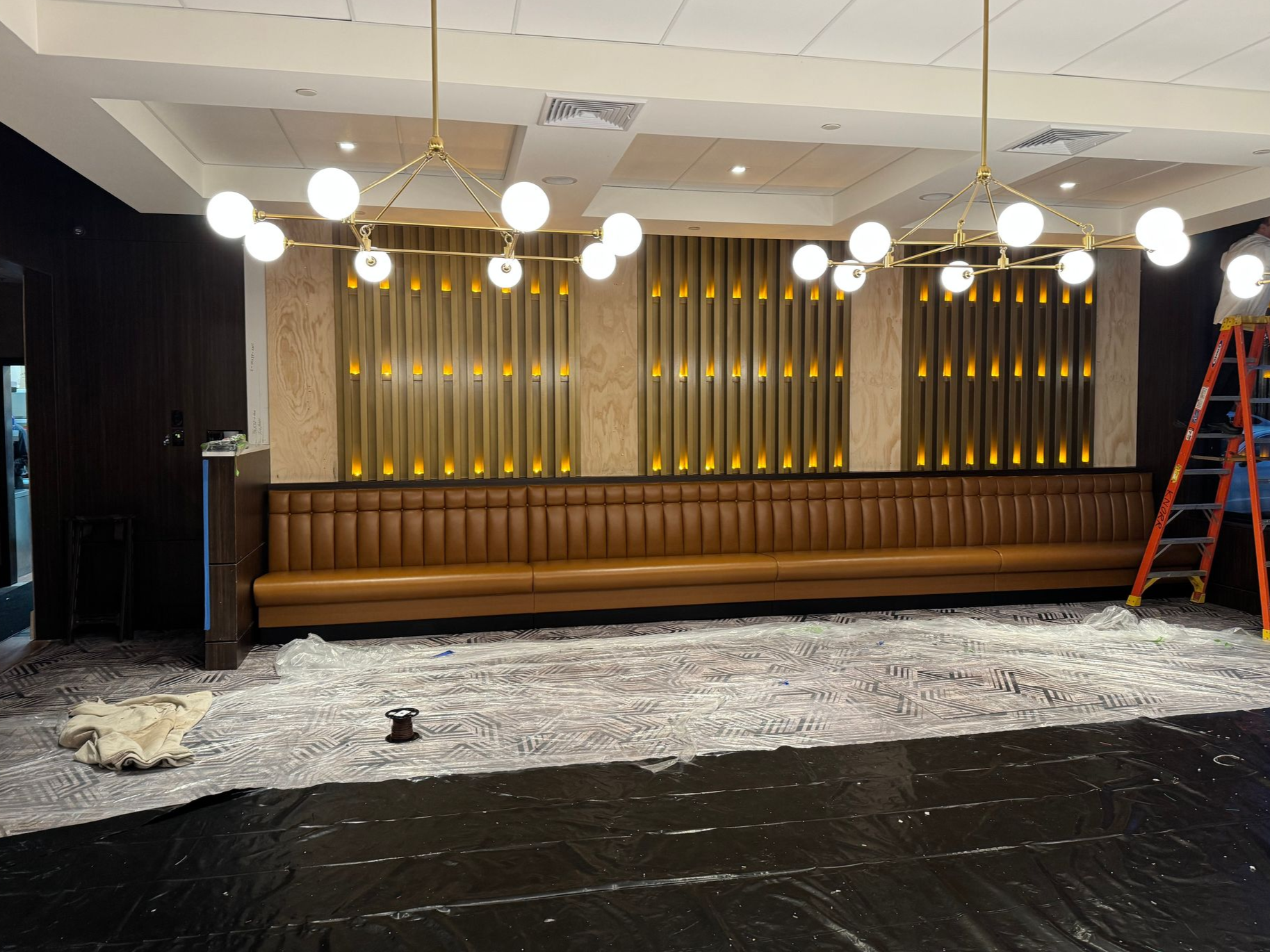 Commercial restaurant dining area with modern pendant light fixtures and decorative wall lighting