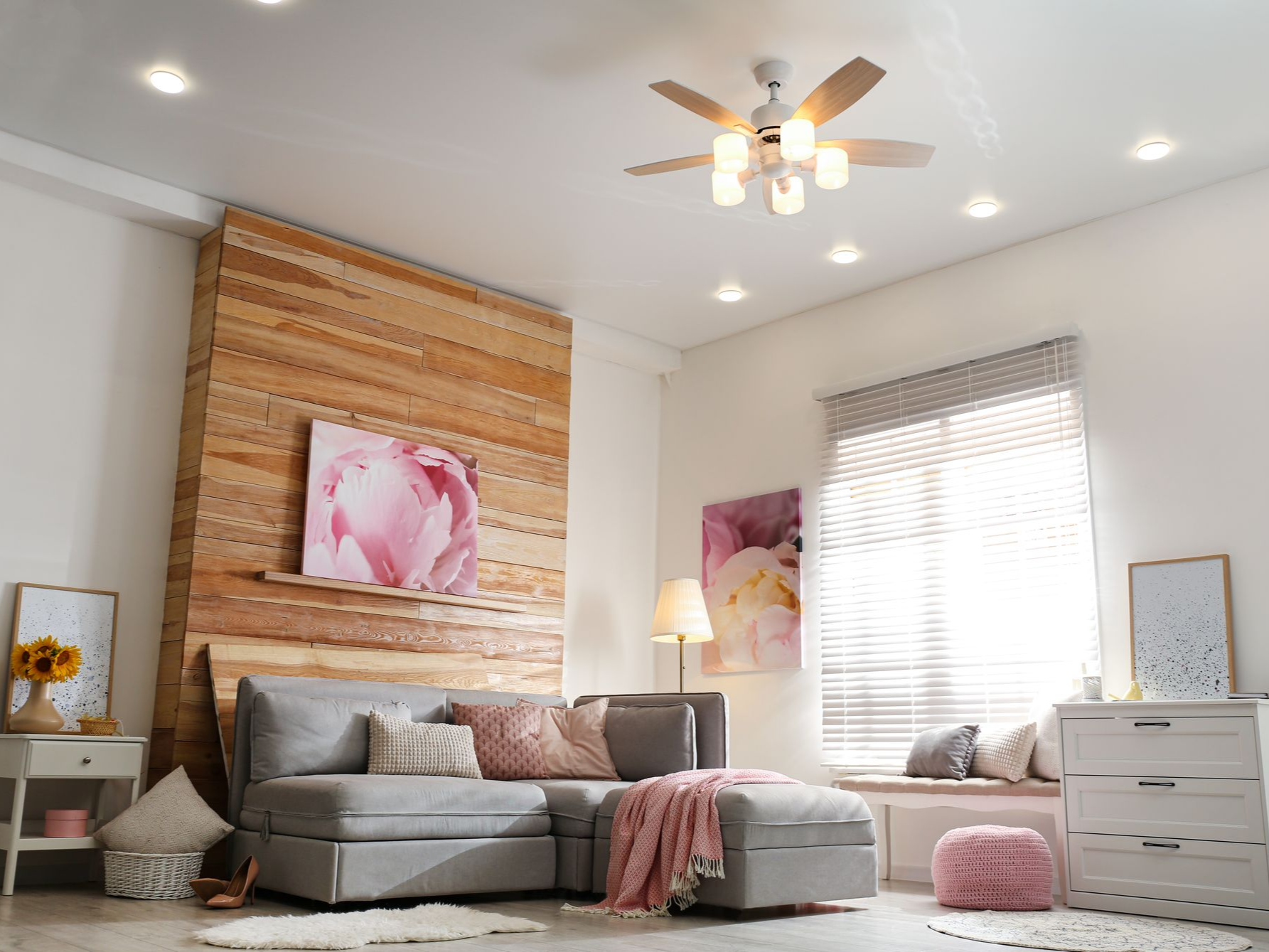 Ceiling fan with integrated lights and recessed lighting in a residential bedroom