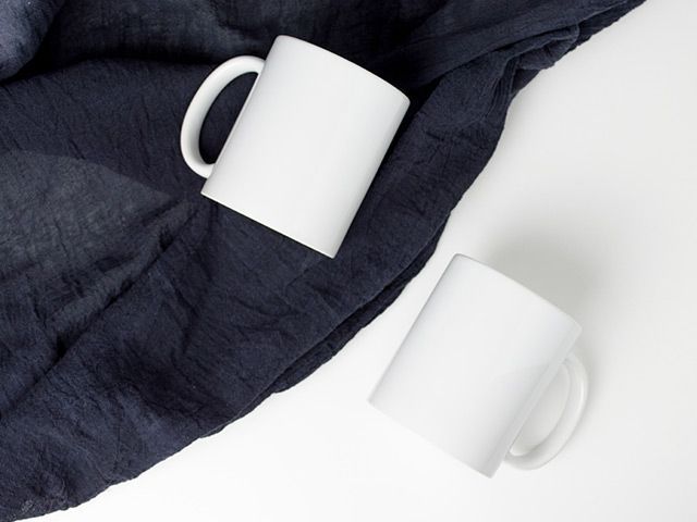 A white coffee mug with a picture of a man and a woman on it