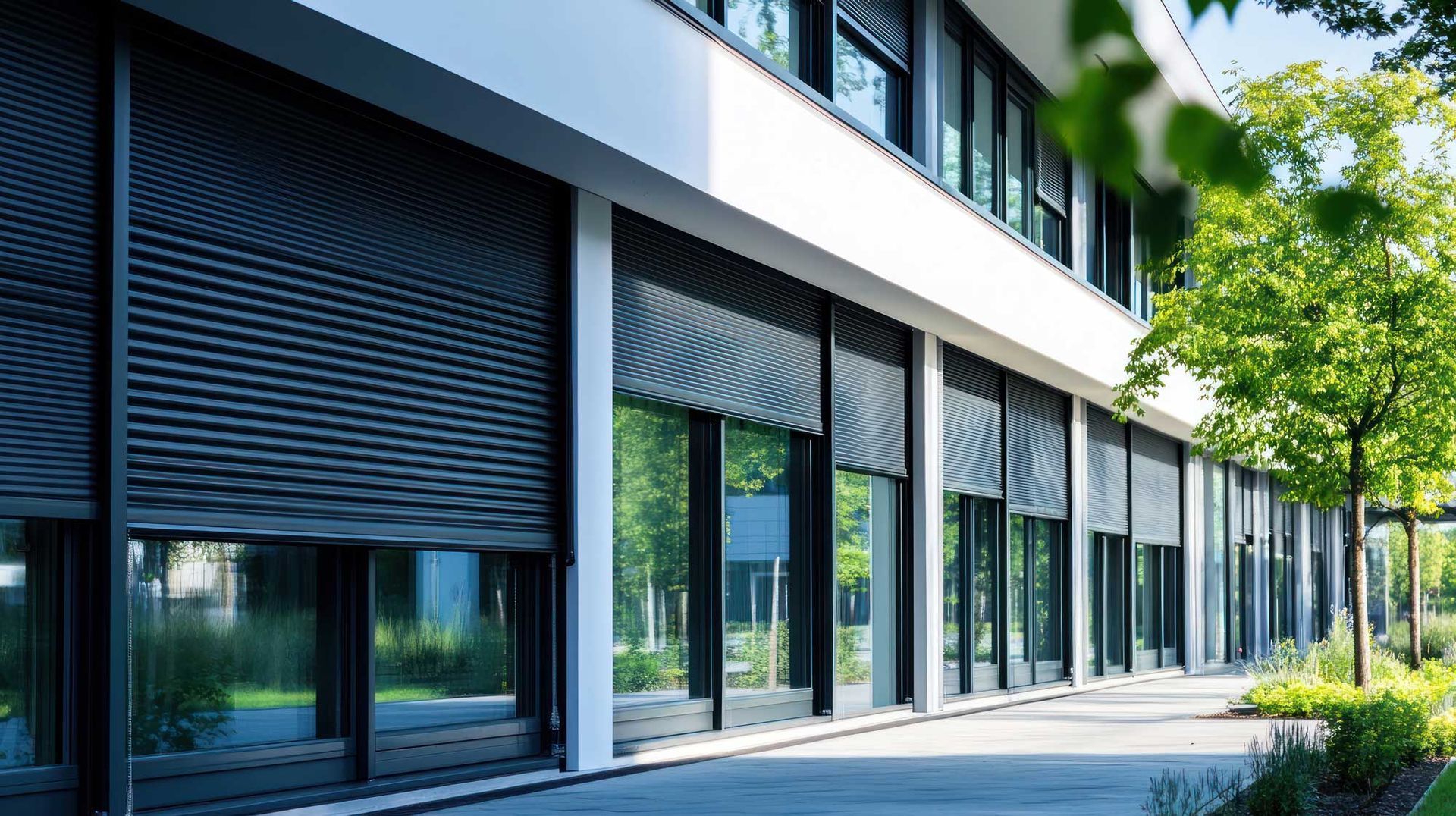 View of several black commercial roller shutters in a store outside View of several black commercial roller shutters in a store outside