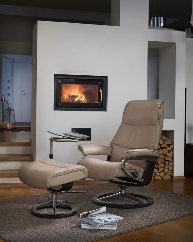 Tan Leather Recliner Chair and Footstool by a Fireplace — Hastings Specialty Furniture In Port Macquarie, NSW