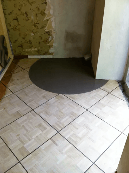 Un sol carrelé avec un cercle noir au milieu