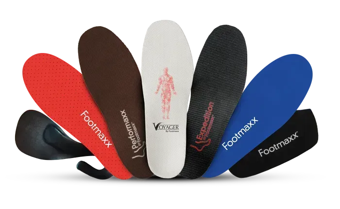 Assorted colorful orthopedic shoe insoles arranged in a fan shape on a white background