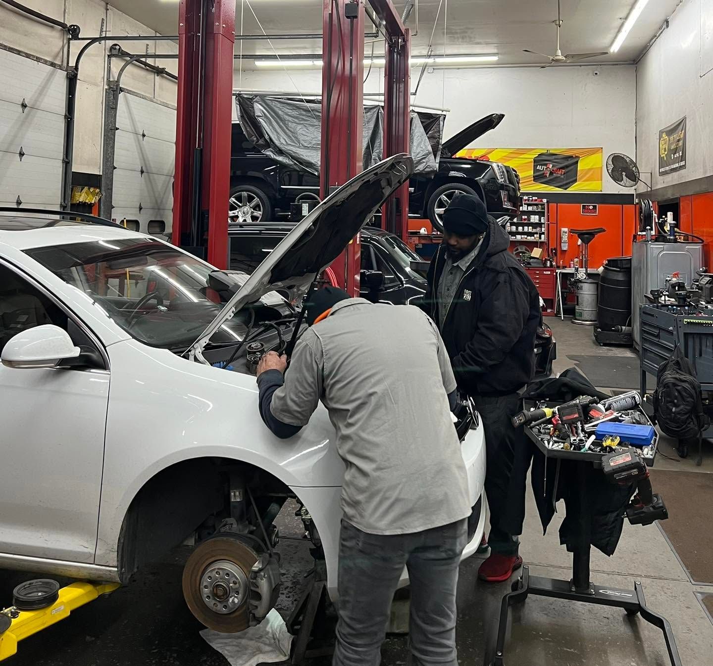 Automotive Technician Servicing White Vehicle With Wheel Removed | CarDoc Automotive