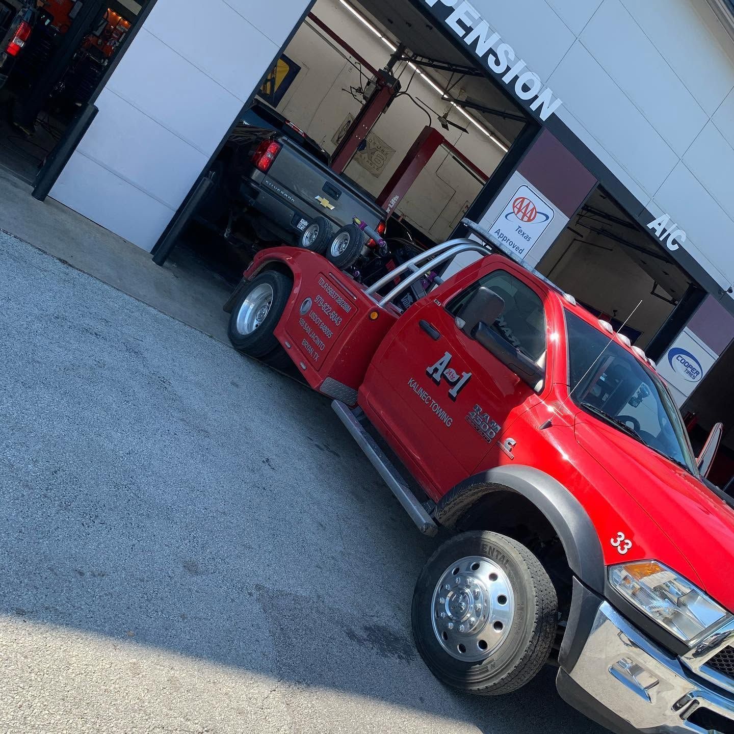 Red Tow Truck Parked Outside Automotive Repair Shop | CarDoc Automotive