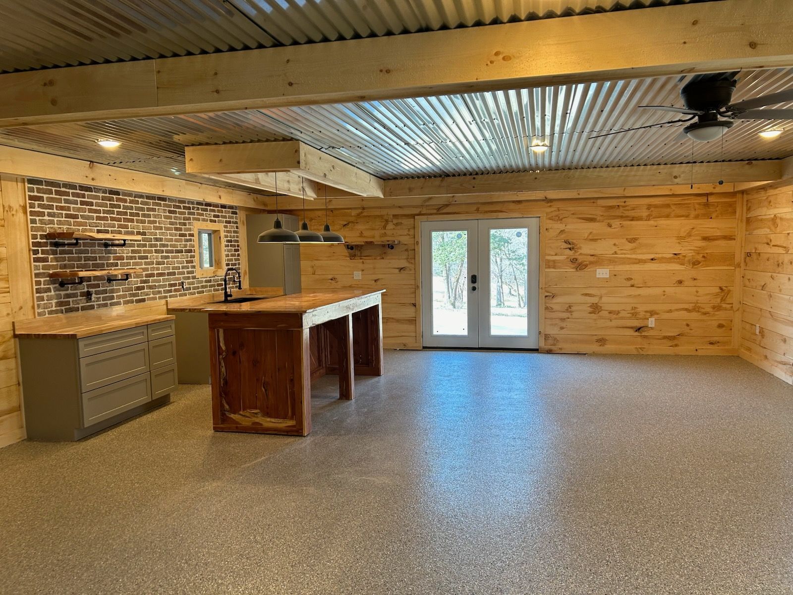 A wooden deck with a fence and trees in the background.