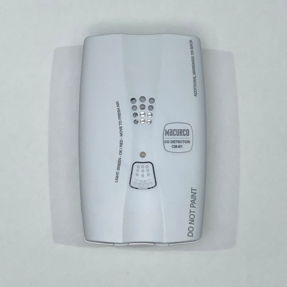 White CO detector against a white background, with a