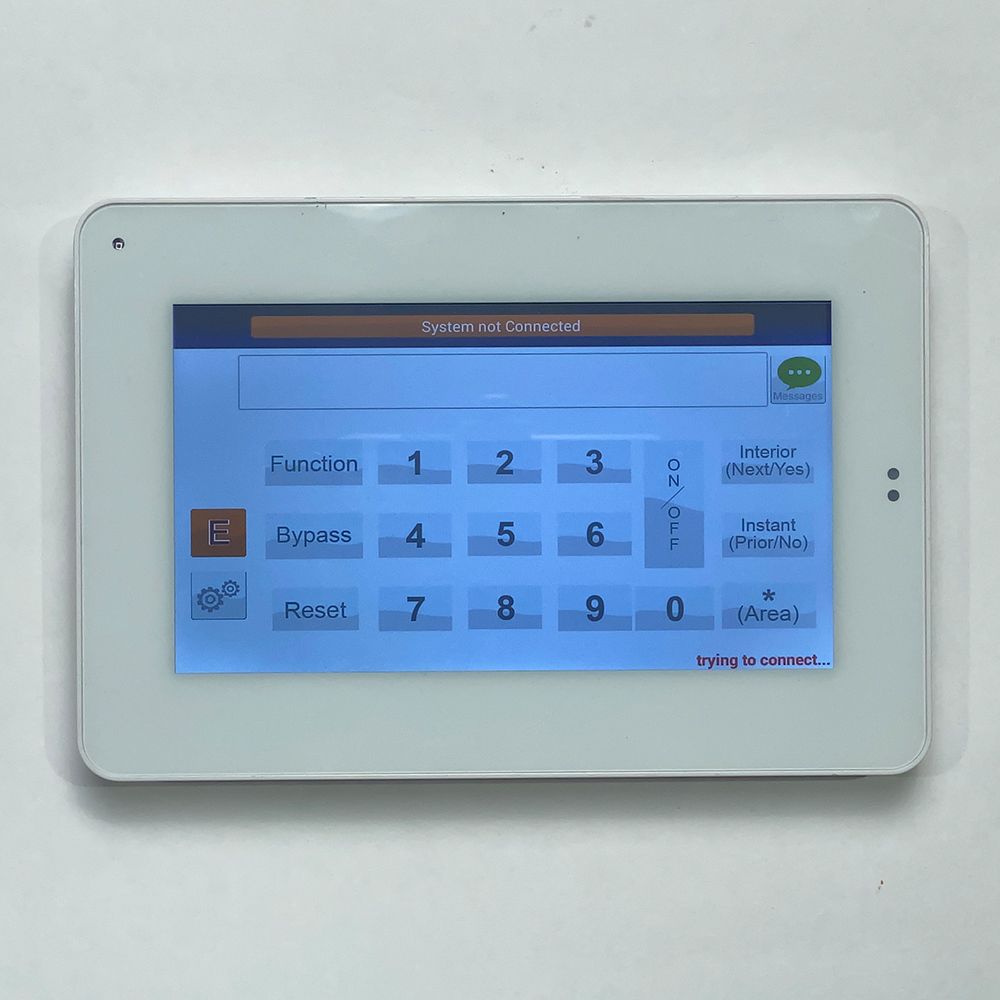 White touch screen device with keypad and system error message displayed on a wall.