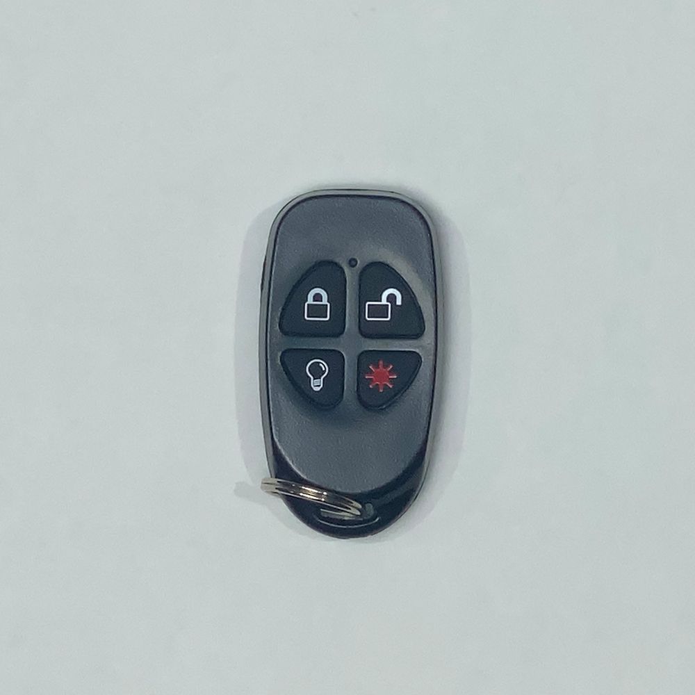 Black car remote with four buttons on a white background.