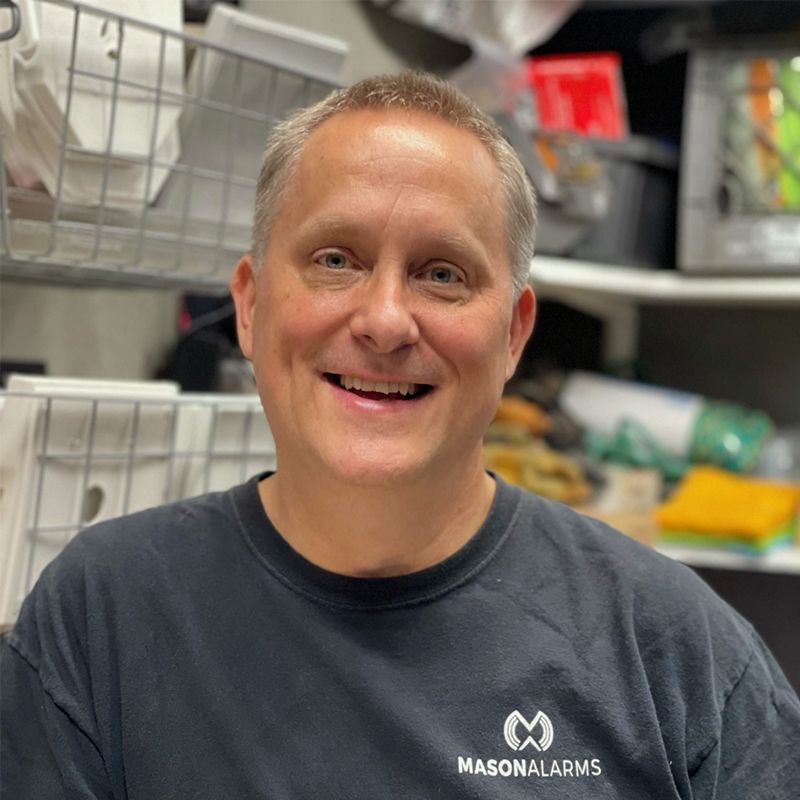 Man smiling, wearing a black shirt with