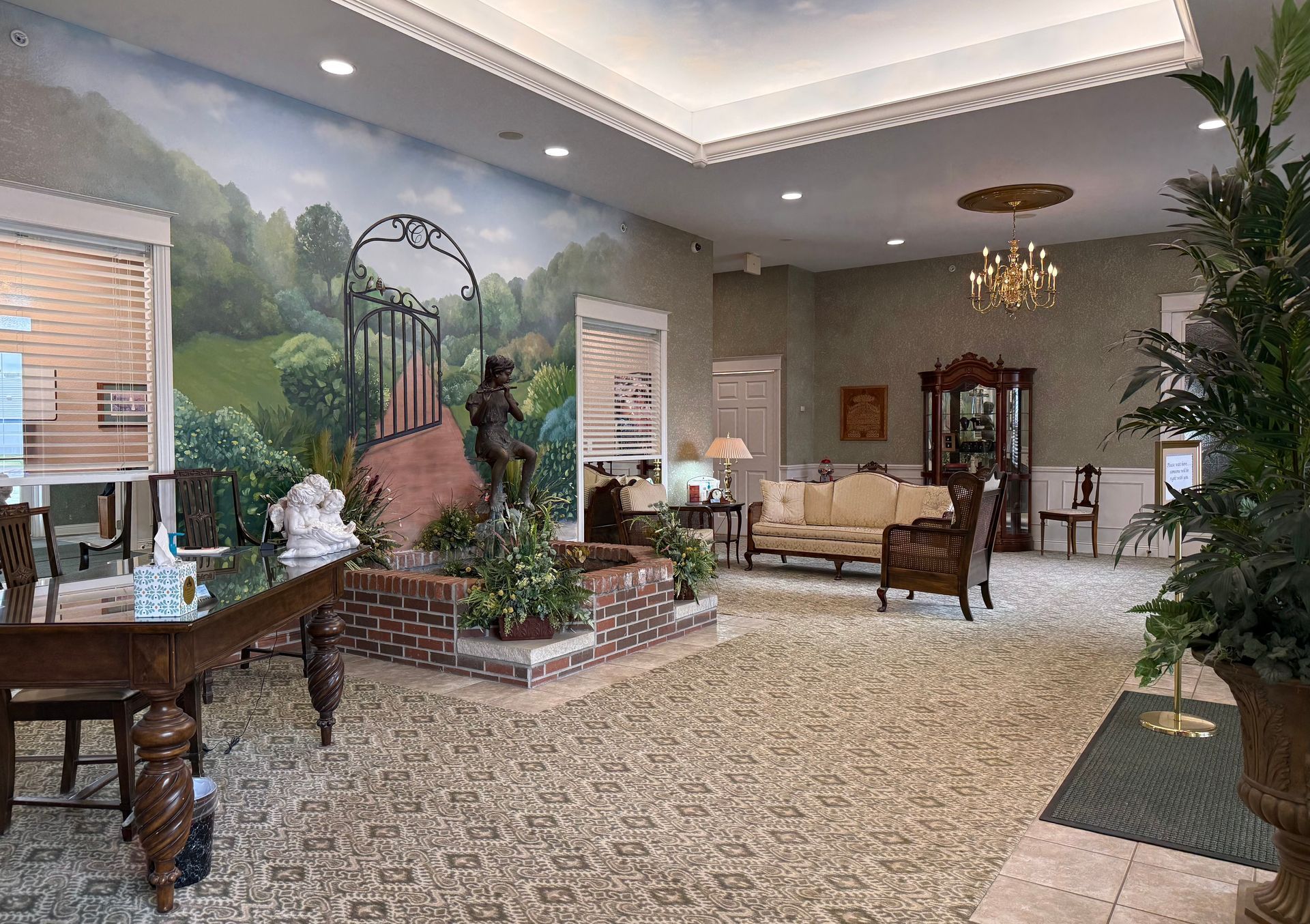 Elegant lobby with carpet, seating, chandelier, and a large garden mural on the wall