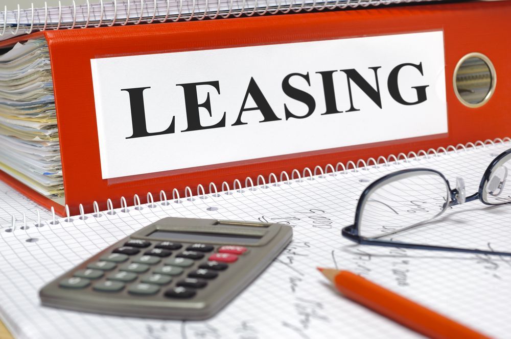 Red Binder Labelled Leasing With Calculator, Glasses, and Pencil — Kellie O'Malley Conveyancing In Lake Munmorah, NSW
