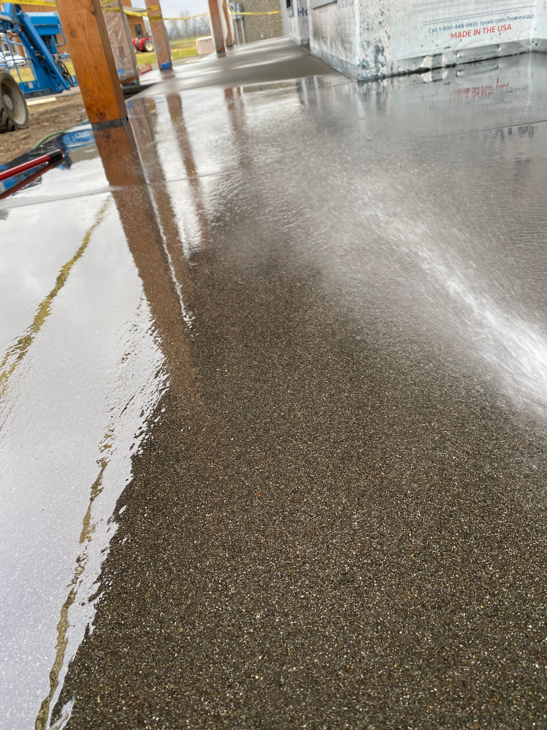 A close up of a concrete floor with a lot of small rocks on it.