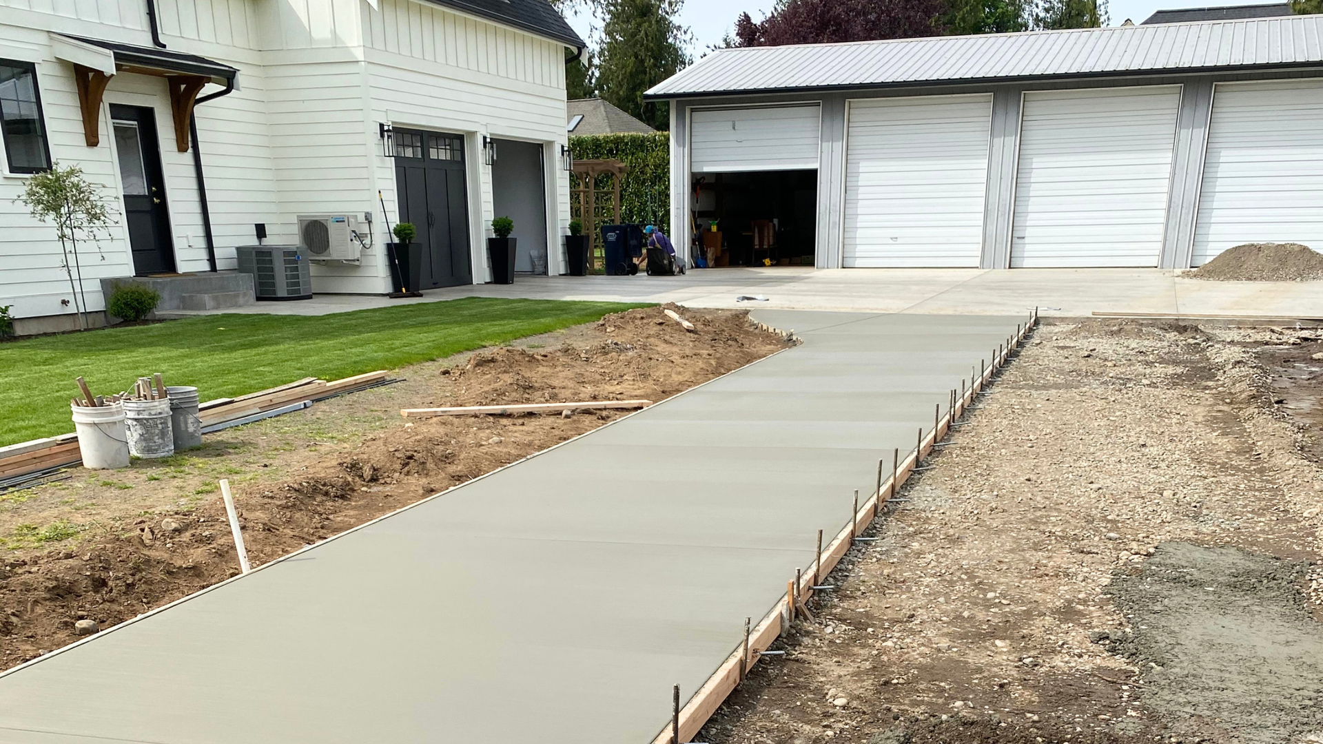 Textured broom-finish concrete walkway with fine grooves for slip resistance at a Bellingham WA home.