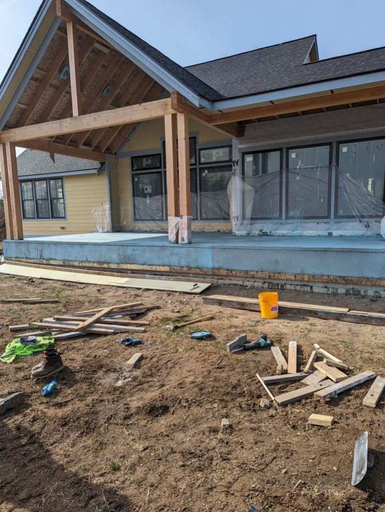 A house is being built with a large porch.