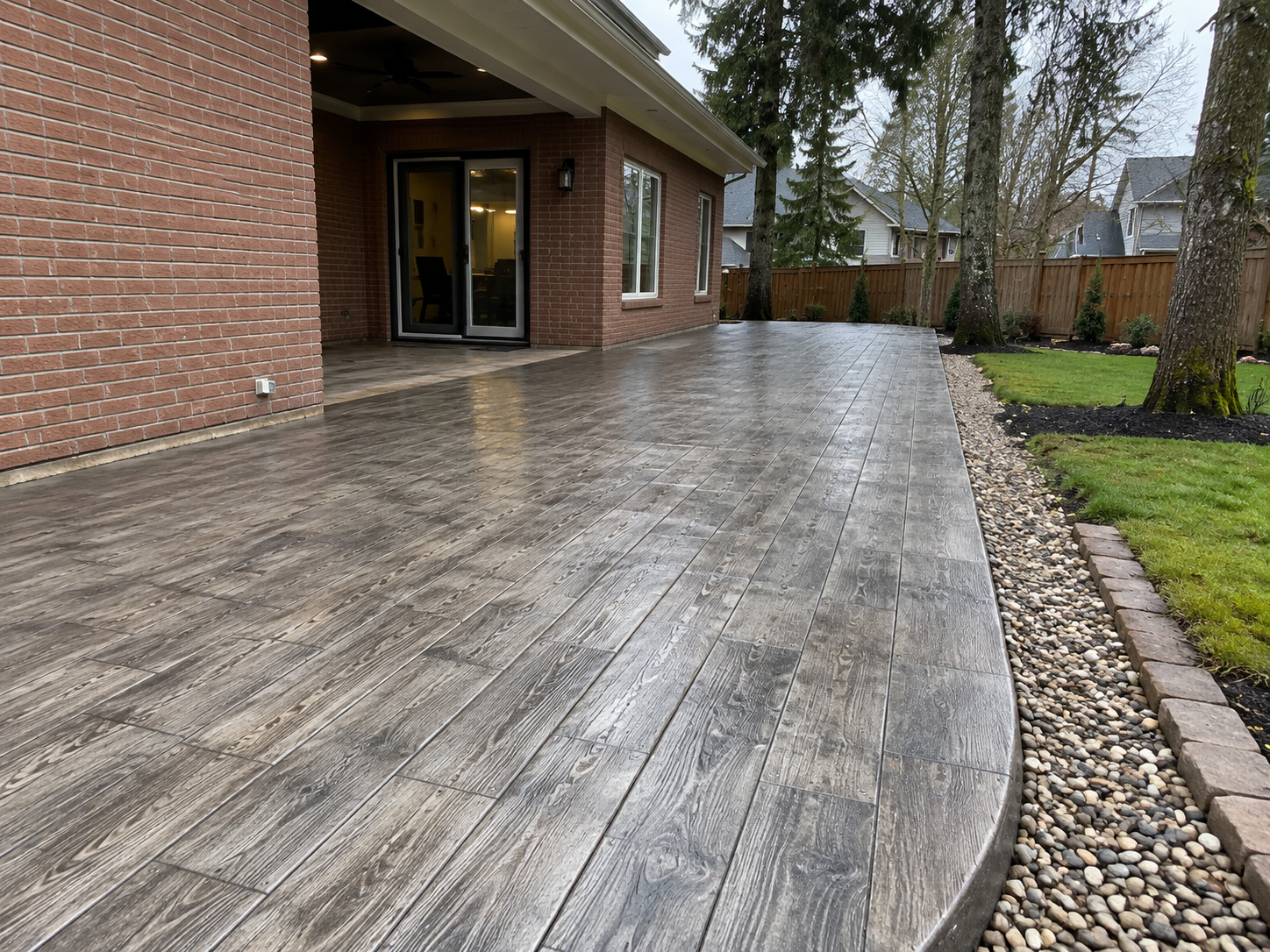 Wood plank stamped concrete patio mimicking timber boards without the rot at a Bellingham WA home.