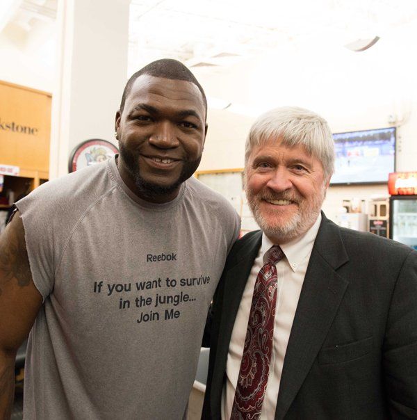 Thomas Oppel with Big Papi wearing a shirt that says if you want to survive in the jungle join me