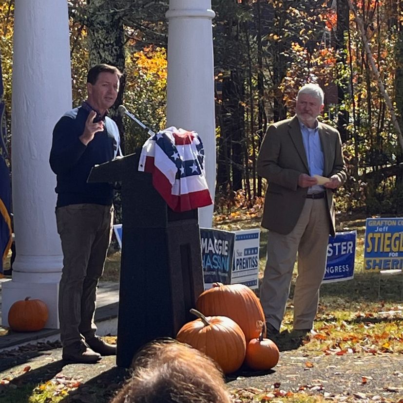 Man at podium speaking outside