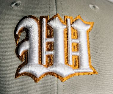 A light beige baseball cap with the words A light beige baseball cap with the words