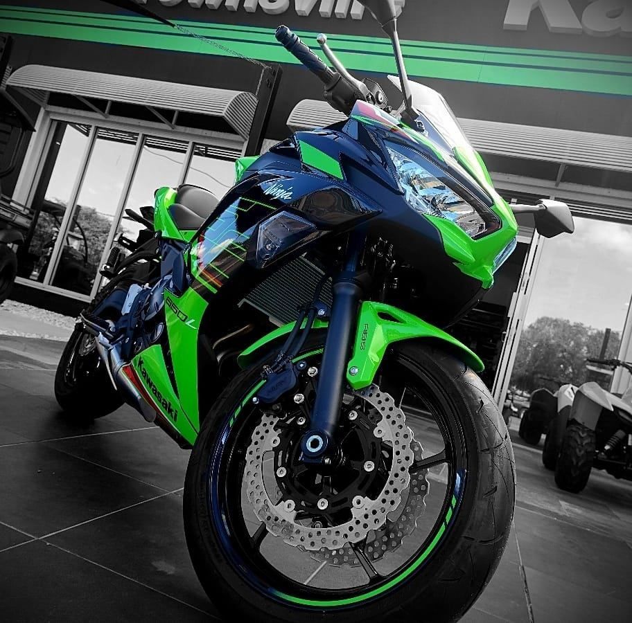 A Green and Blue Motorcycle is Parked in Front of a Store — Mackay Kawasaki in Townsville, QLD