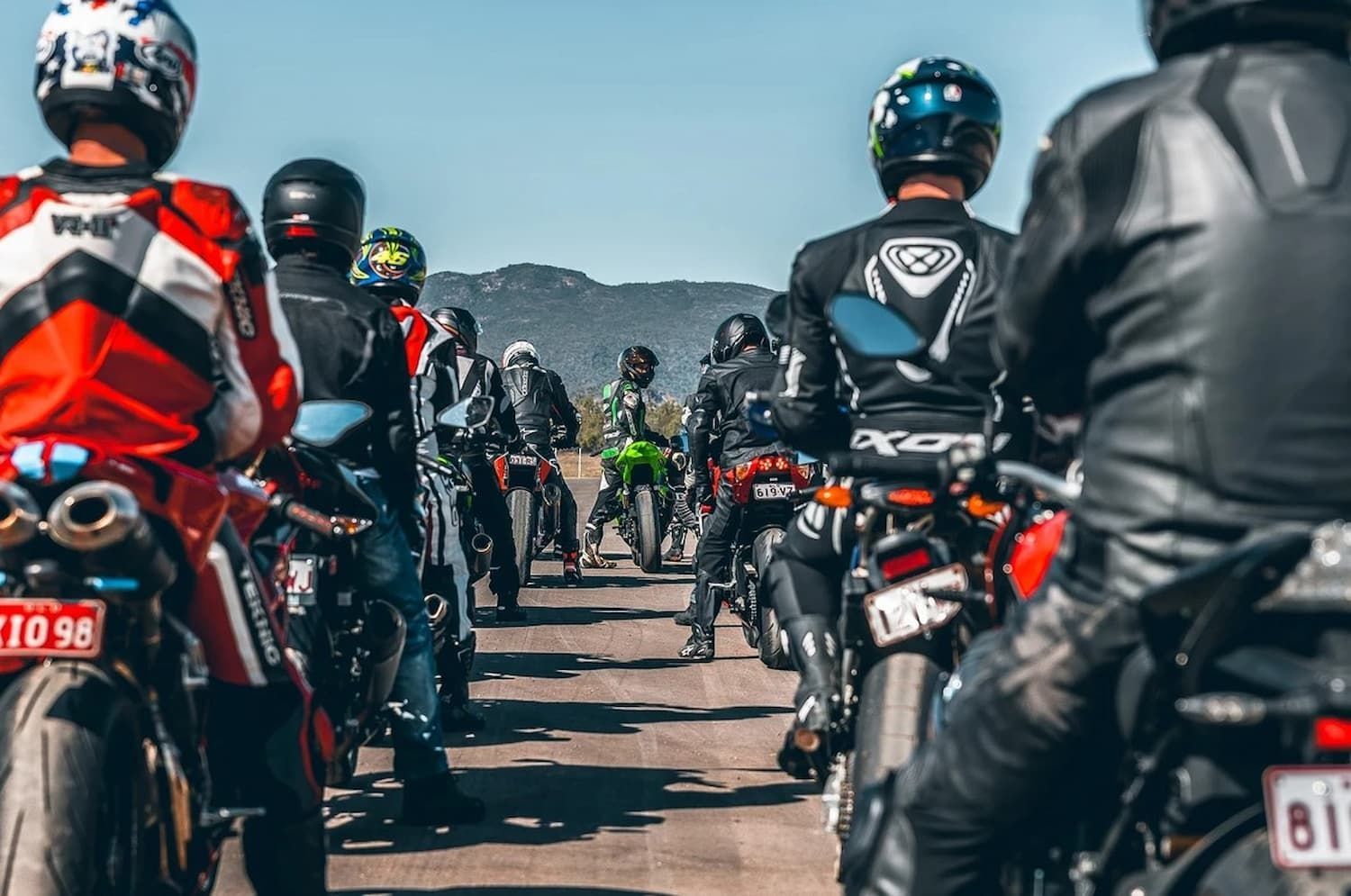 A Group of People Are Riding Motorcycles Down a Road — Mackay Kawasaki in North Mackay, QLD
