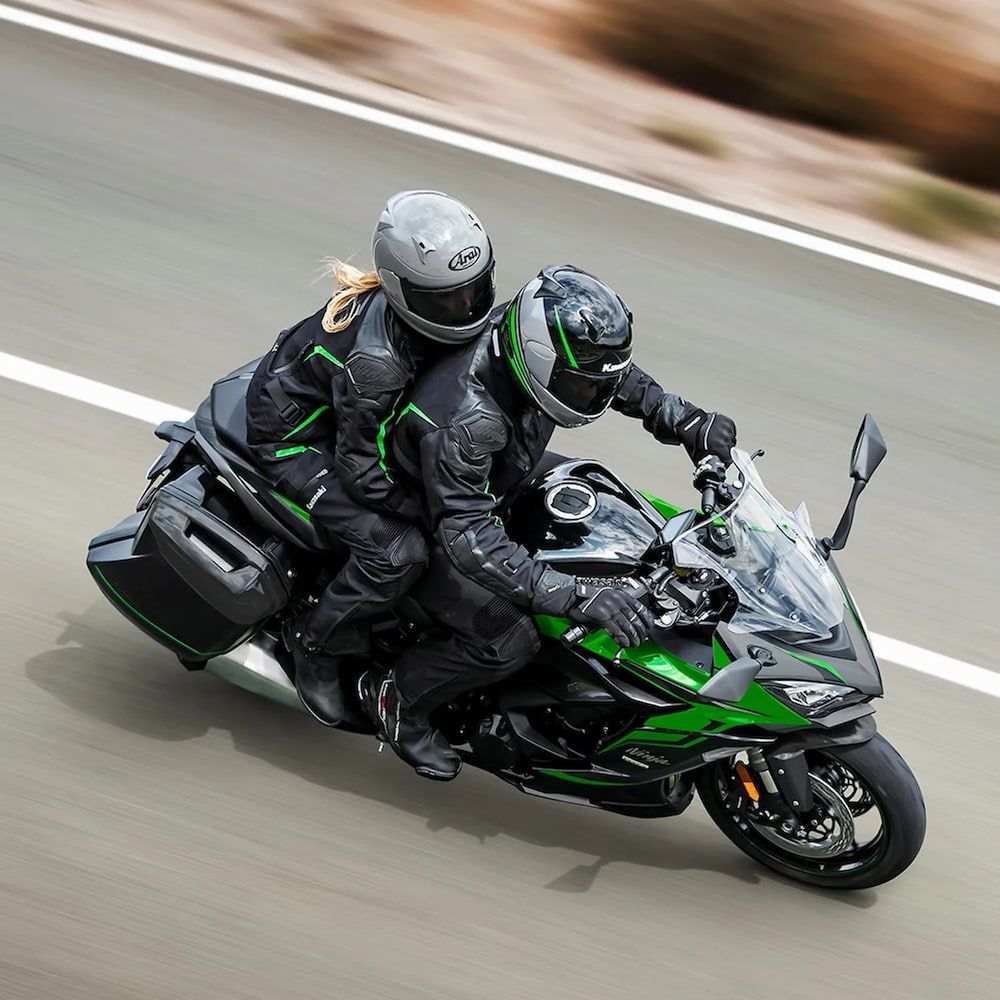 Two People Are Riding a Motorcycle Down a Road — Mackay Kawasaki in North Mackay, QLD