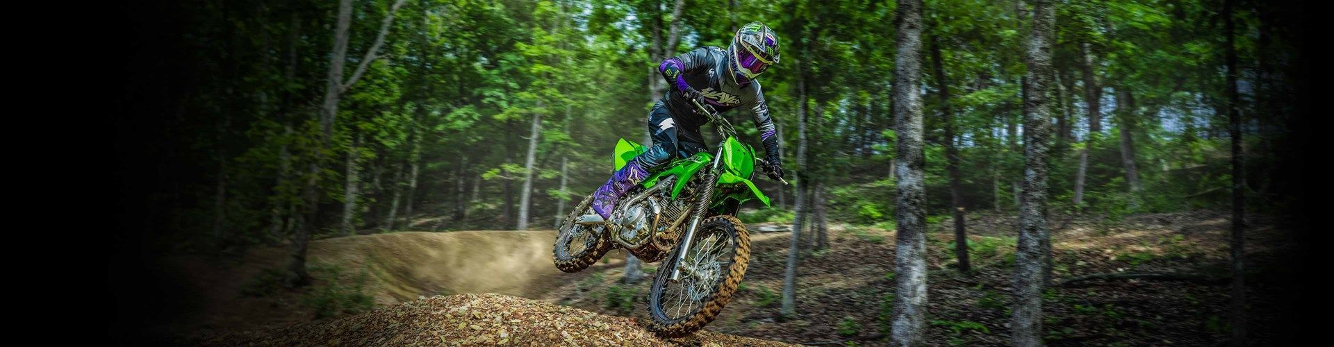 A Man Is Riding A Motorbike On A Dirt Track — Mackay Kawasaki in North Mackay, QLD